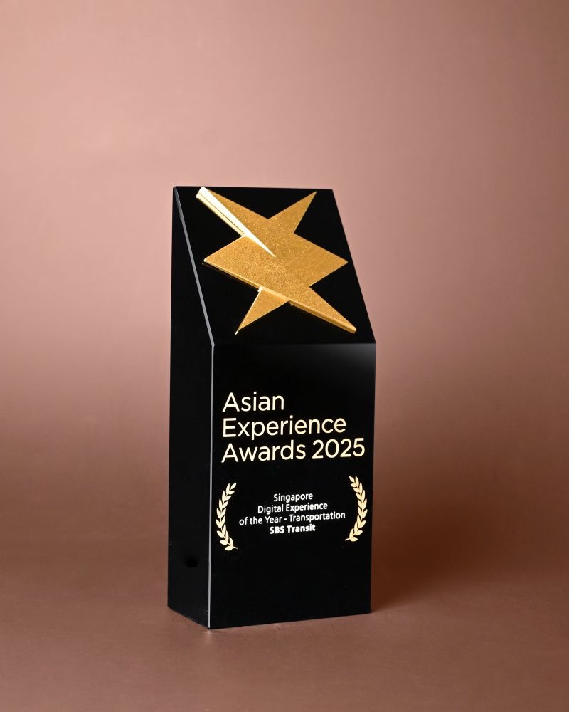 A black Asian Experience Awards 2025 trophy topped with a gold star, inscribed Singapore Digital Experience of the Year – Transportation, SBS Transit.